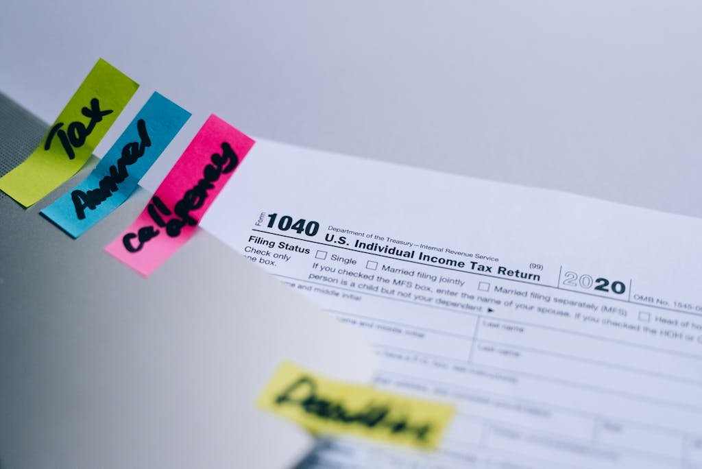 Close-up of 1040 U.S. tax form with colorful sticky notes for organization.